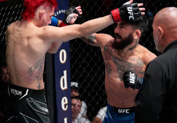 Guido Cannetti of Argentina punches Kris Moutinho in their bantamweight fight during the UFC Fight Night event at UFC APEX on March 12, 2022 in Las...