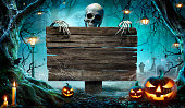 Halloween Party Card - Pumpkins And Skeleton In Graveyard At Night With Wooden Board