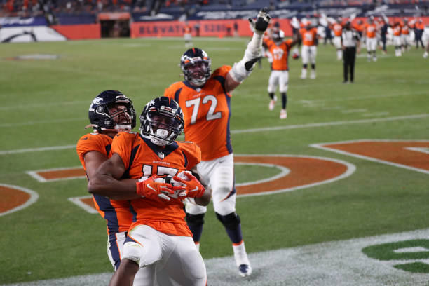 Hamler of the Denver Broncos celebrates with teammates Albert Okwuegbunam and Garett Balles after scoring a touchdown against the Los Angeles...