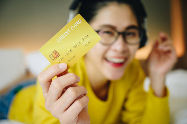 happiness woman holding a yellow credit card in her hand picture
