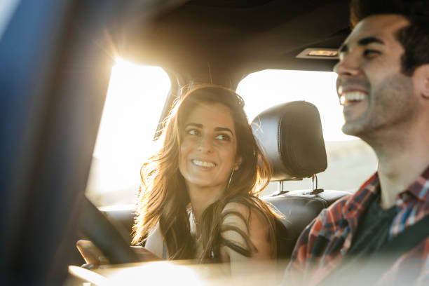 happy couple driving in car on road trip - happy couple stock pictures, royalty-free photos & images