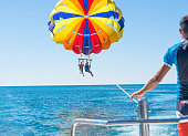 Happy couple Parasailing in Dominicana beach in summer