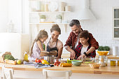 Happy family cooking together on home kitchen