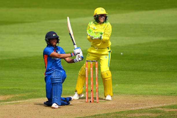 Harmanpreet Kaur of Team India hits out as Alyssa Healy of Team Australia watches on during the Cricket T20 Preliminary Round Group A match between...