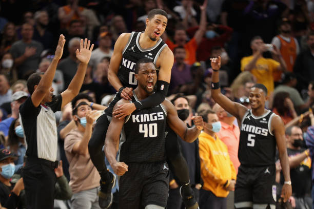 Harrison Barnes of the Sacramento Kings celebrates with Tyrese Haliburton and De'Aaron Fox after Barnes hit the game-winning three-point shot against...