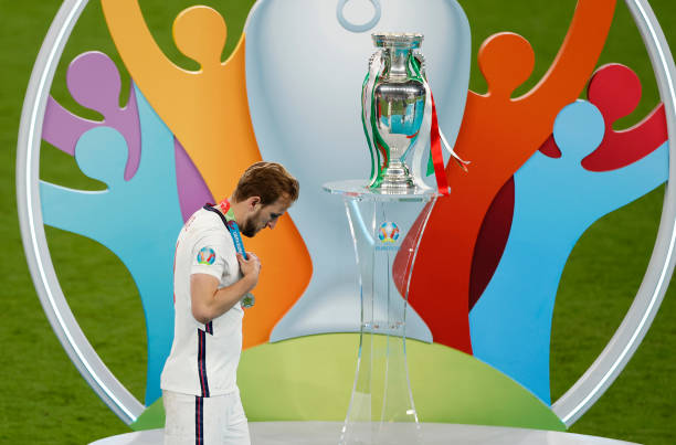 Harry Kane of England walks past the Henri Delaunay Trophy following his team's defeat in the UEFA Euro 2020 Championship Final between Italy and...