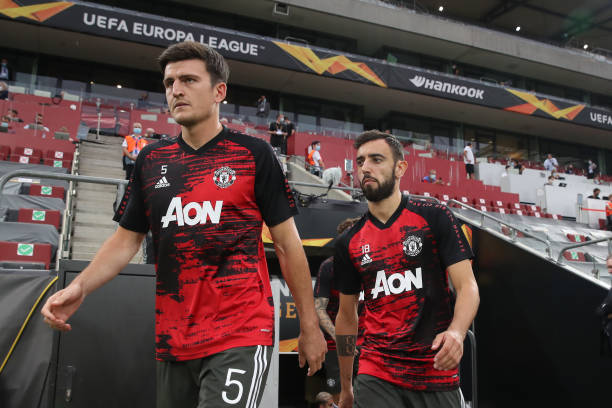 Harry Maguire and Bruno Fernandes of Manchester United walk out to warm up prior to the UEFA Europa League Semi Final between Sevilla and Manchester...