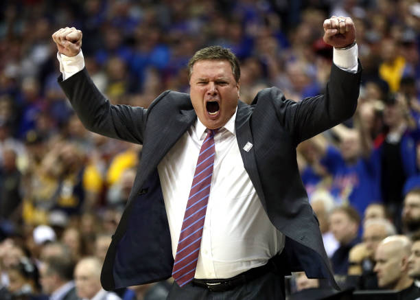 Head coach Bill Self of the Kansas Jayhawks celebrates as the Jayhawks defeat the West Virginia Mountaineers 81-70 to win the Big 12 Basketball...