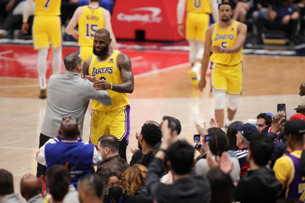 Head Coach Frank Vogel hi-fives LeBron James of the Los Angeles Lakers after he passes Karl Malone on the NBA all-time scoring list during the game...