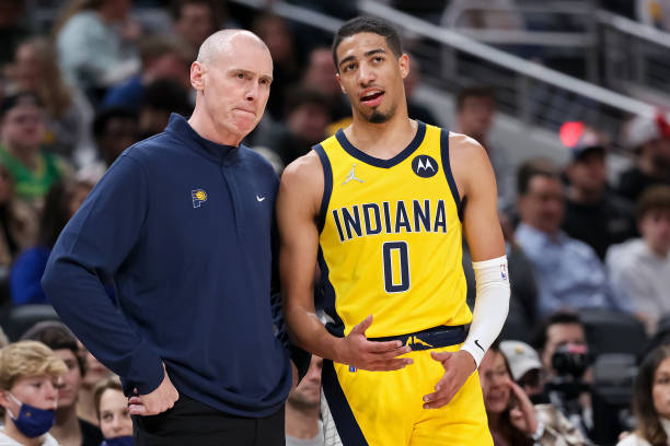 Head coach Rick Carlisle of the Indiana Pacers meets with Tyrese Haliburton in the second quarter against the Cleveland Cavaliers at Gainbridge...