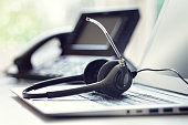 Headset headphones telephone and laptop in call center