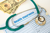 Health insurance with insurance claim form and stethoscope.