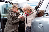 Helping a Senior Woman Out of the Car