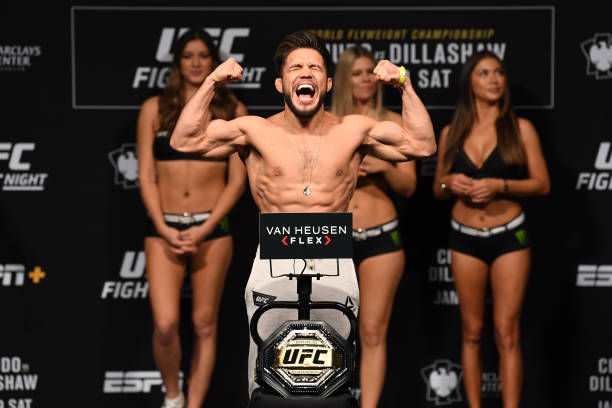 Henry Cejudo poses on the scale during the UFC Fight Night weigh-in at Barclays Center on January 18, 2019 in the Brooklyn borough of New York City.