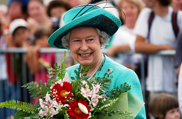Her Majesty Queen Elizabeth II smiles at waiting fans after attending a church service at St Andrews Anglican Church in Taupo with the Duke of...