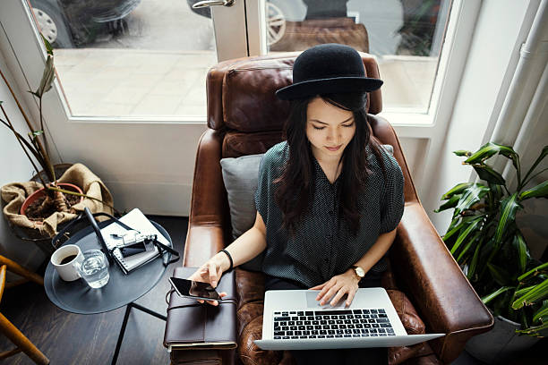 high angle view of creative businesswoman working while sitting on picture