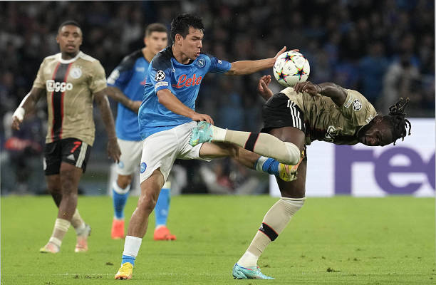 Hirving Lozano of SSC Napoli competes for the ball with Calvin Bassey of AFC Ajax during the UEFA Champions League group A match between SSC Napoli...