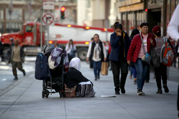 Homeless woman begs for change as pedestrians walk by on November 25, 2019 in San Francisco, California. The Trump administration could be preparing...