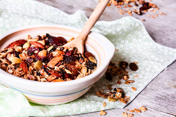 Homemade granola or muesli with toasted almonds, raisin, cranberry in a bowl for healthy breakfast, selective focus