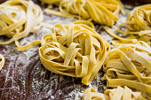 Homemade pasta on a wooden background. Italian style cuisine. Restaurant.