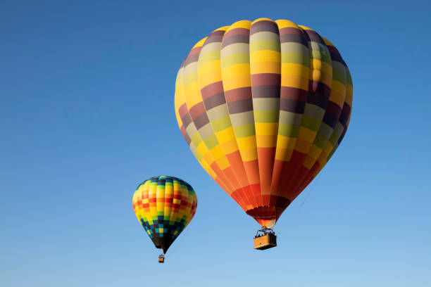 hot air balloons flying together above california winery - ballon rides shoreline stock pictures, royalty-free photos & images
