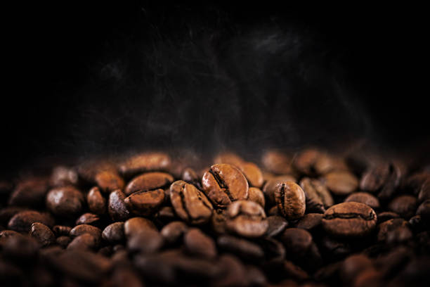 hot coffee beans with soft water vapor - coffee stock pictures, royalty-free photos & images
