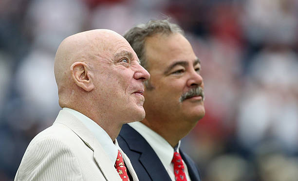 Houston Texans owner Robert McNair waits on the field with his son Cal before their game against the Kansas City Chiefs at NRG Stadium on September...