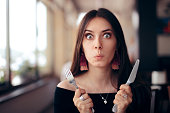 Hungry Woman with Knife and Fork Ready to Eat