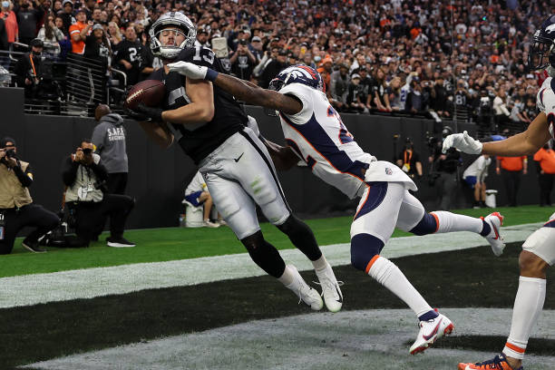 Hunter Renfrow of the Las Vegas Raiders catches a touchdown pass in the end zone against Kareem Jackson of the Denver Broncos in the second quarter...