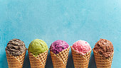 ice cream scoops in cones with copy space on blue