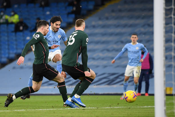Ilkay Gundogan of Manchester City scores their side's second goal whilst under pressure from Pierre-Emile Hojbjerg and Eric Dier of Tottenham Hotspur...