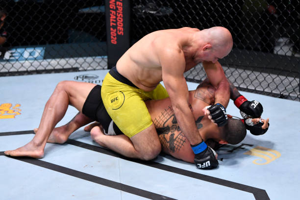 In this handout image provided by UFC, Glover Teixeira of Brazil punches Thiago Santos of Brazil in a light heavyweight fight during the UFC Fight...