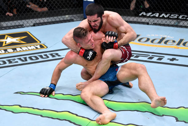In this handout image provided by UFC, Islam Makhachev works for a submission against Drew Dober in their lightweight fight during the UFC 259 event...