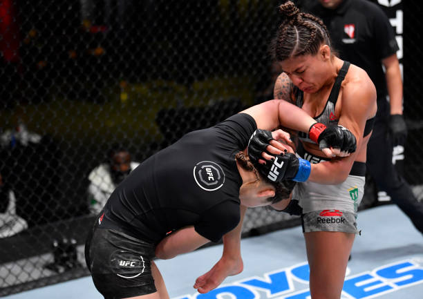 In this handout image provided by UFC, Mayra Bueno Silva of Brazil knees Montana De La Rosa in a flyweight bout during the UFC Fight Night event at...