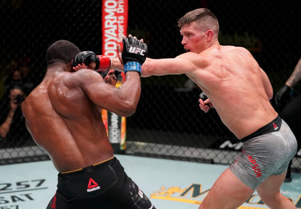 In this handout image provided by UFC, Stephen Thompson punches Geoff Neal in a welterweight fight during the UFC Fight Night event at UFC APEX on...