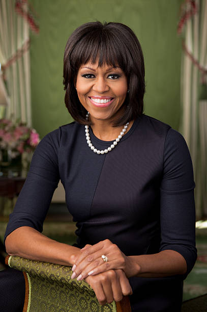 In this handout provided by the White House first lady Michelle Obama poses in the Green Room of the White House for her official photograph made...