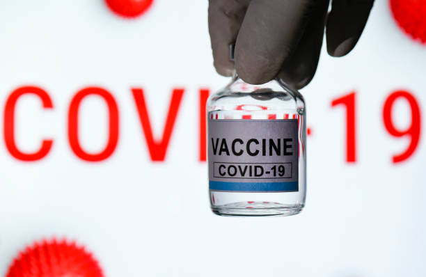 In this photo illustration a doctor holds a bottle labelled as the Covid-19 coronavirus vaccine in Guwahati, India on 28 November 2020. Prime...