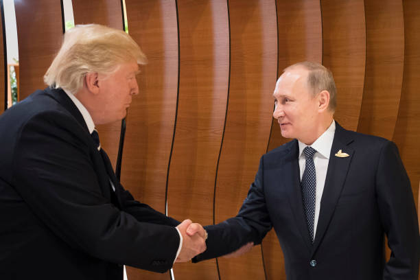 In this photo provided by the German Government Press Office Donald Trump President of the USA meets Vladimir Putin President of Russia at the...
