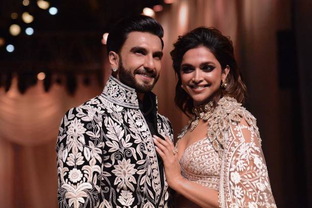 In this picture taken on July 29 Bollywood actors Ranveer Singh and Deepika Padukone walk the ramp for Mijwan Welfare Society and fashion show by...