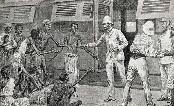 India: The Famine In India--Passengers by the Bombay Mail Buying And Distributing Bread To Starving Peasants At A Country Station On The East Indian...