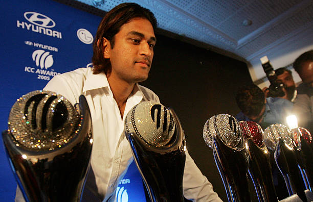Indian cricketer Mahindra Singh Dhoni poses with Swarovski designed ICC trophies at CCI on Wednesday.