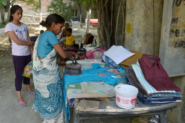 Indian ironing lady Anjali is watched by a customer as she uses a charcoal iron to press clothes on a street in Amritsar on May 11 2017 She charges... Punjabi Songs Online Listen and Download Videos, Images