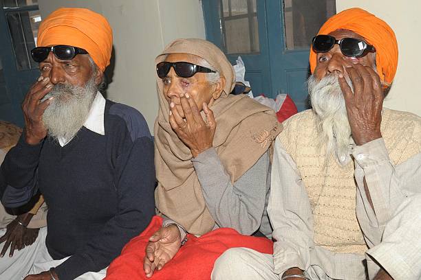 Indian patients Joginder Singh Payar Kaur and Joginder Singh who lost their eyesight after undergoing surgery at an eye camp show their damaged eyes..