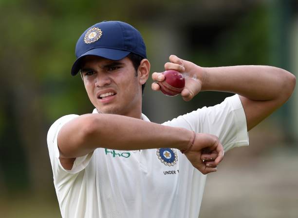 Indian under-19 cricketer Arjun Tendulkar, son of the Indian former cricket superstar Sachin Tendulkar, holds a ball during a practice session before...