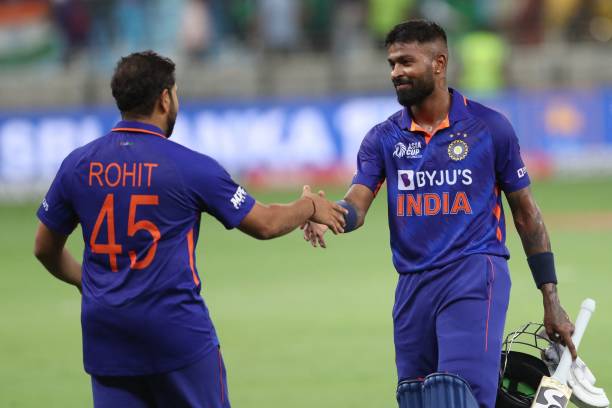 India's Hardik Pandya shakes hands with his team captain Rohit Sharma after winning the Asia Cup Twenty20 international cricket Group A match between...