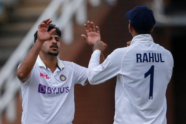 India's Shardul Thakur celebrates with teammate India's KL Rahul after dismissing South Africa's Kyle Verreynne during the second day of the second...