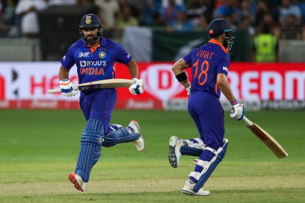 India's Virat Kohli and team captain Rohit Sharma take a run during the Asia Cup Twenty20 international cricket Group A match between India and...