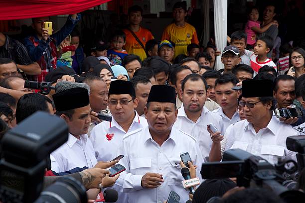 Indonesian Presidential Candidate Prabowo Subianto speaks with reporters after voting in his local polling station on July 9 2014 in Bojong Koneng...