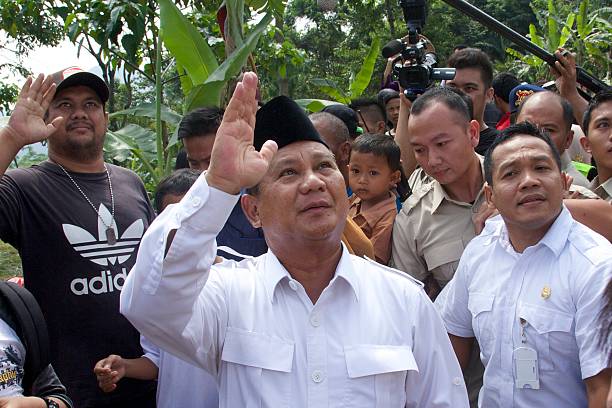 Indonesian Presidential Candidate Prabowo Subianto waves to the crowd after voting in his local polling station on July 9 2014 in Bojong Koneng...