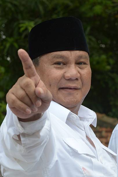Indonesian presidential candidate Probowo Subianto gestures after registration as president and vice president at the general elections commission...